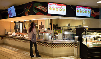 Student in cafeteria looking at options